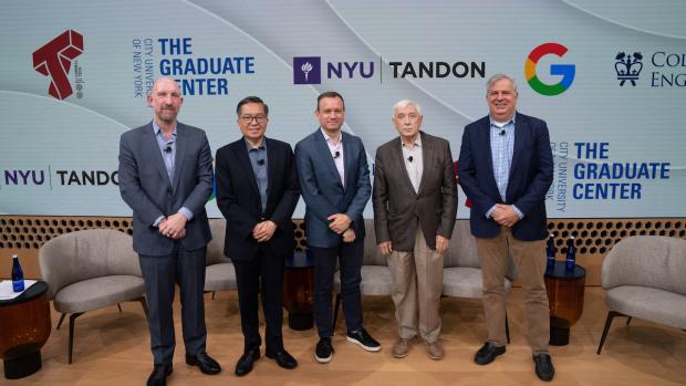 group of men standing on stage in front of step and repeat