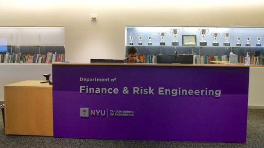 The FRE Department lobby desk with a glass case full of trophies 