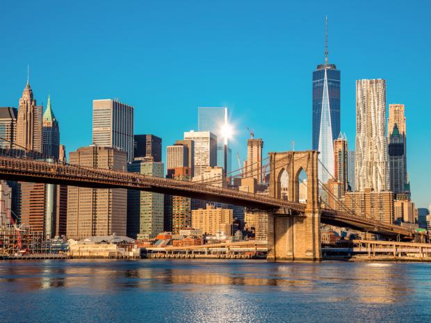 sunny view of Brooklyn Bridge with downtown Manhattan in the background